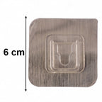 Transparent wall hook attached to smooth indoor surface