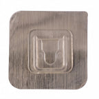 Close-up of sticky transparent wall hook installation